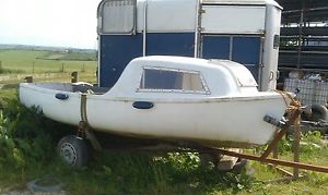 fishing or cruising boat with cuddy and trailer