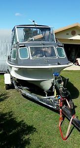 Half cabin boat 4.5 meter savage tasman with trailer .