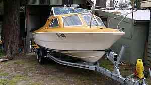 boat 5.4m Stejcraft half cabin on as new savage trailer