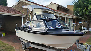 Stejcraft 14ft Half Cabin boat with evinrude 55hp outboard, dunbier trailer