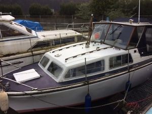 Cabin Motor Cruiser River Boat. Grove Ferry river mooring